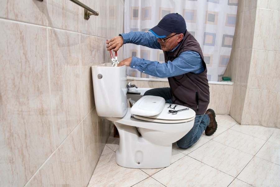 Plumber working on a toilet