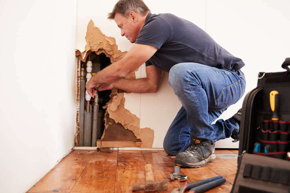 Man repairing a broken pipe